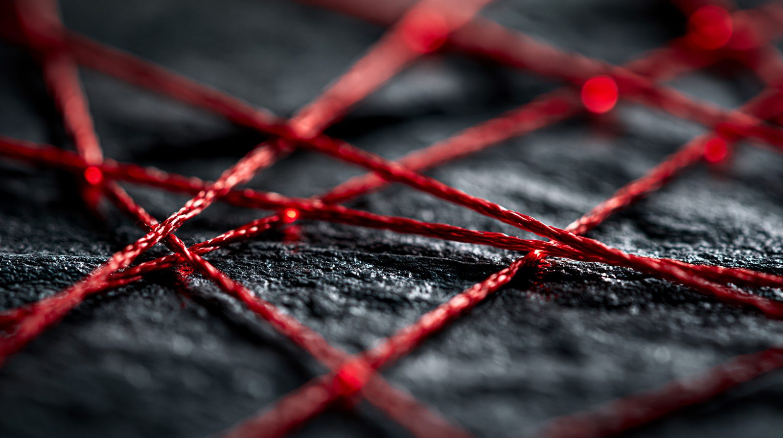 A network of red silk threads connecting points